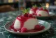 Malinová panna cotta zdobená čerstvým bobulovým ovocem a malinovou omáčkou